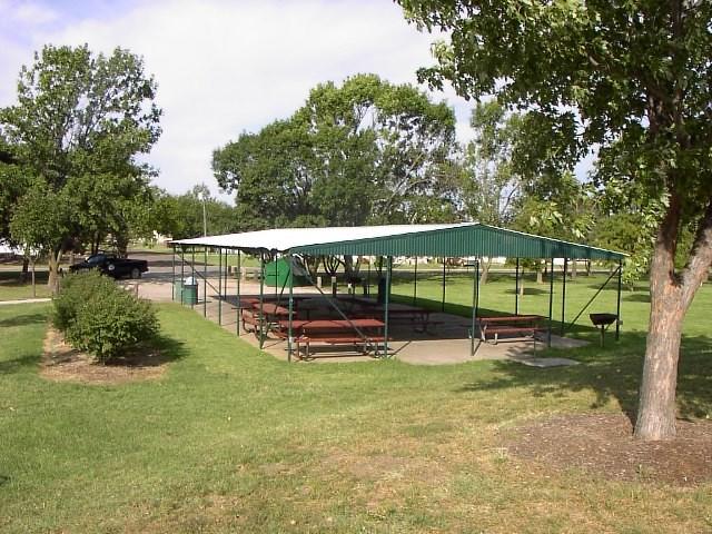 A picnic area with tables and chairs placed on the grass